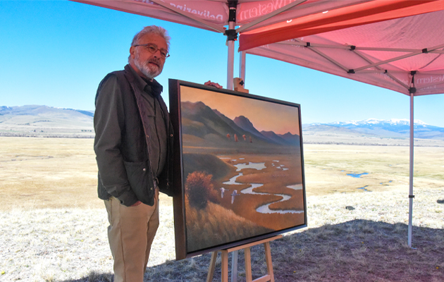Artist Monte Dolack stands in front of his painting of ODell Creek
